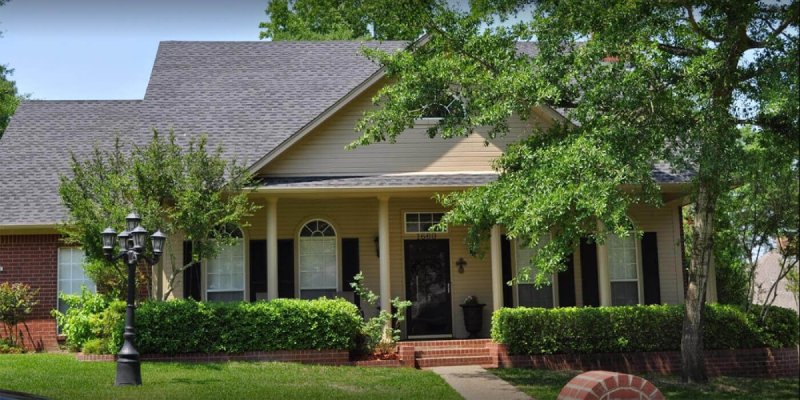 Dark roof house with column porch in East Texas